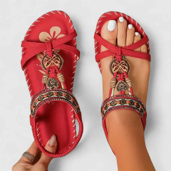 Women's embellished T-strap sandals in red with beaded detailing and elastic ankle strap shown from above