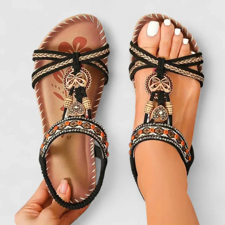Detail shot of women's T-strap sandals highlighting decorative beadwork and supportive footbed construction