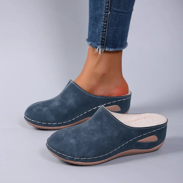 Overhead view of orthopaedic cozy slippers displaying rounded toe shape and supportive arch construction