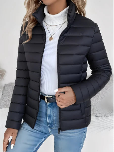 Close-up view of the lightweight quilted spring jacket showing horizontal channel stitching and tailored fit