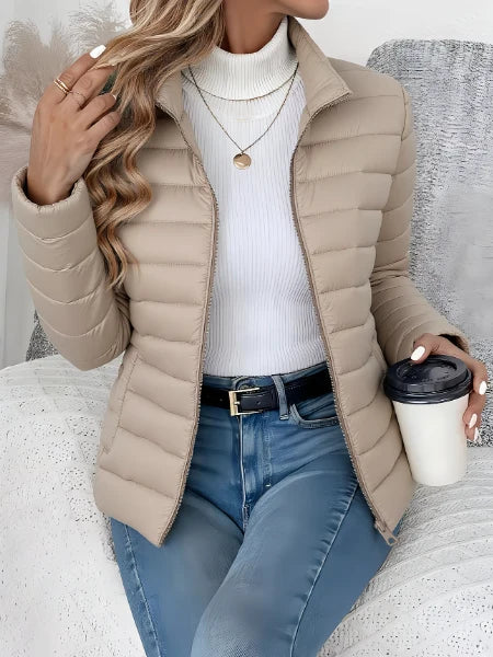 Side profile of the women's quilted spring jacket displaying the hip-length hem and structured silhouette
