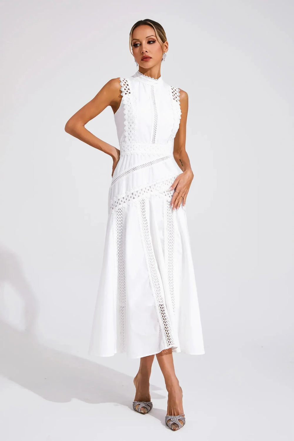Front view of sleeveless midi dress showing intricate lace panel detailing throughout bodice and skirt