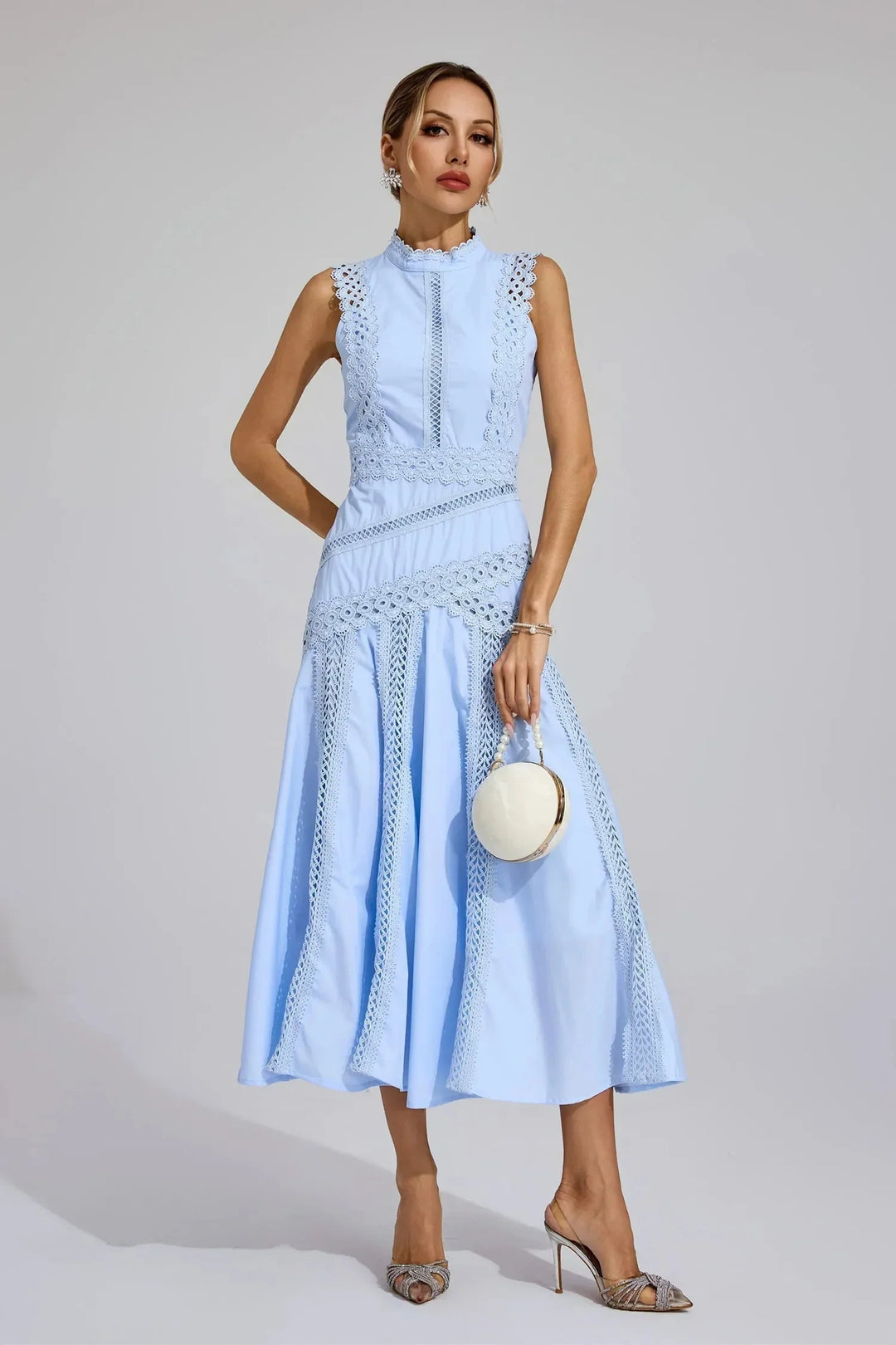 Close-up of openwork lace inserts and structured bodice on yellow midi dress