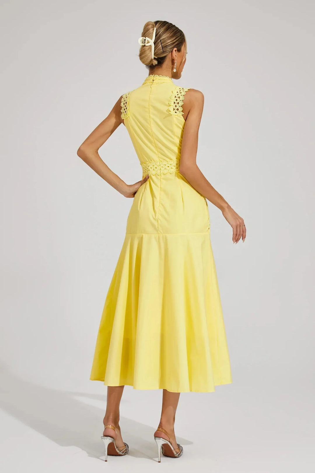 Styling shot of lace panel midi dress paired with strappy heels for summer occasions