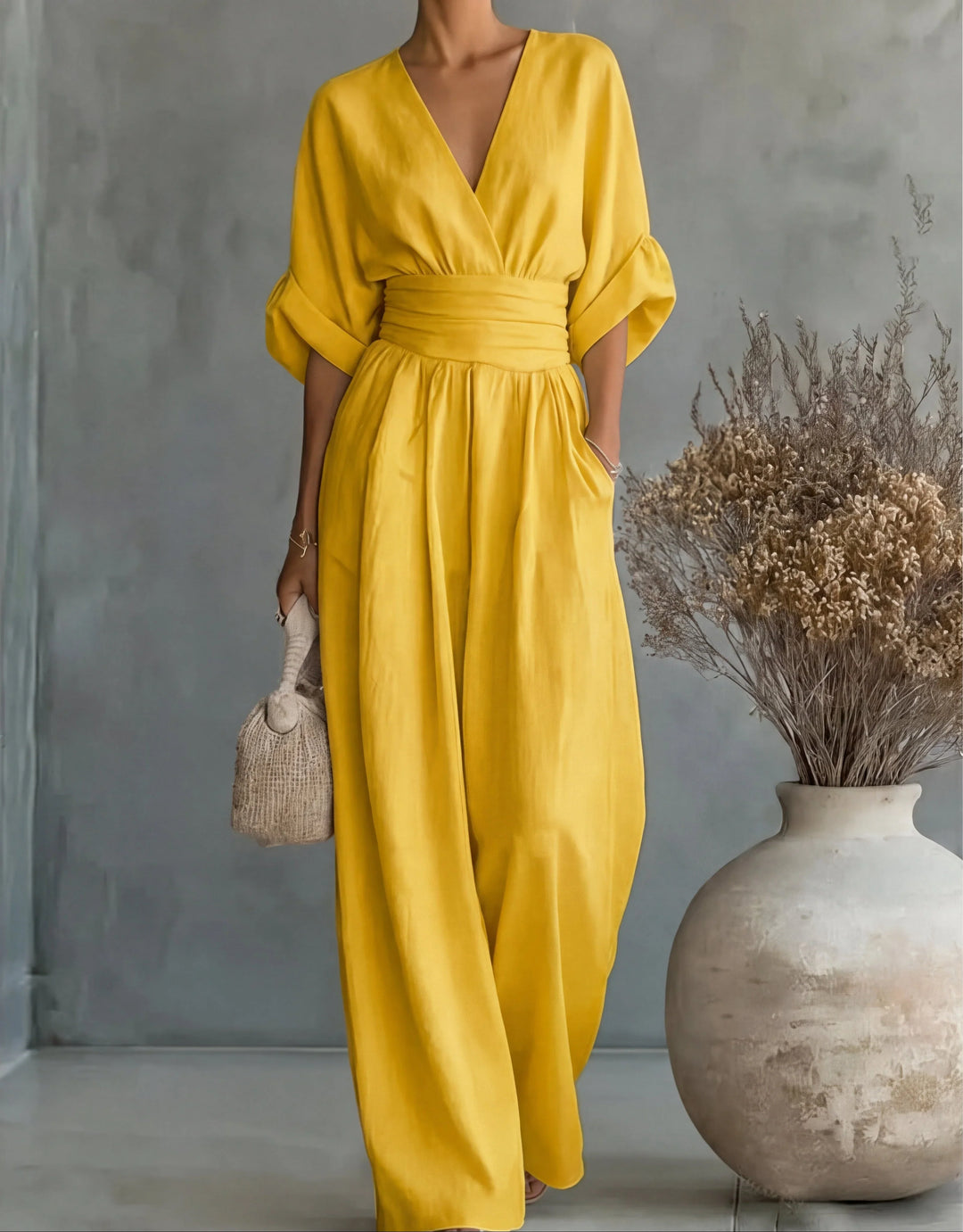 Black wide-leg jumpsuit with wrap bodice and gathered waist detail