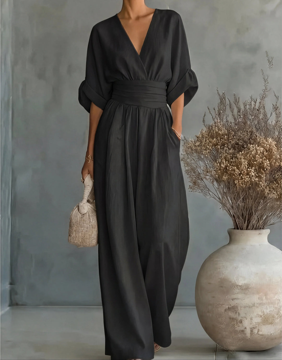 Orange wide-leg jumpsuit with V-neckline and flowing wide-leg trousers