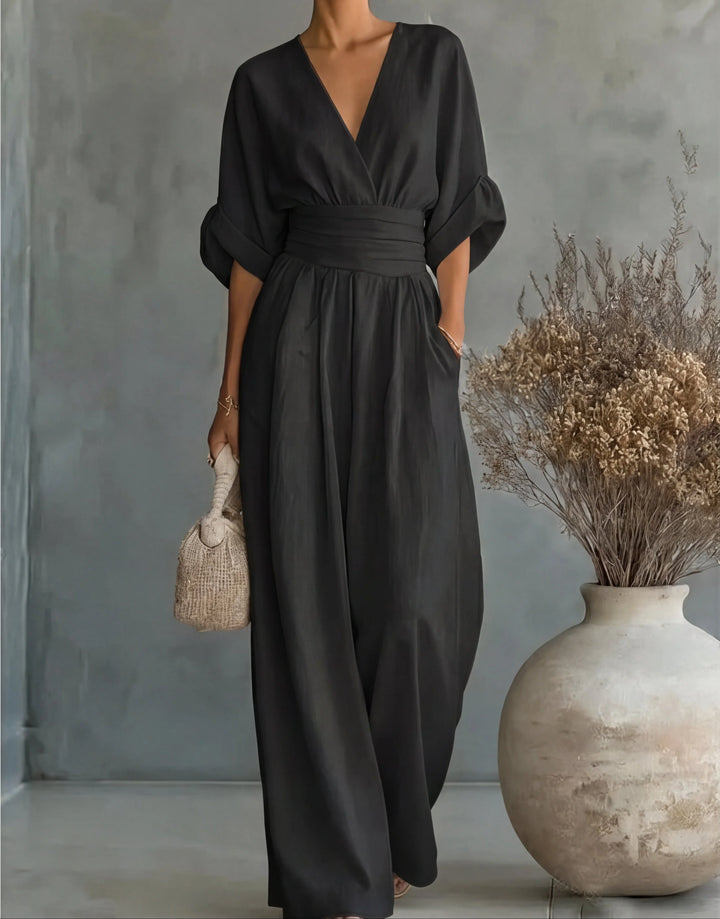 Orange wide-leg jumpsuit with V-neckline and flowing wide-leg trousers