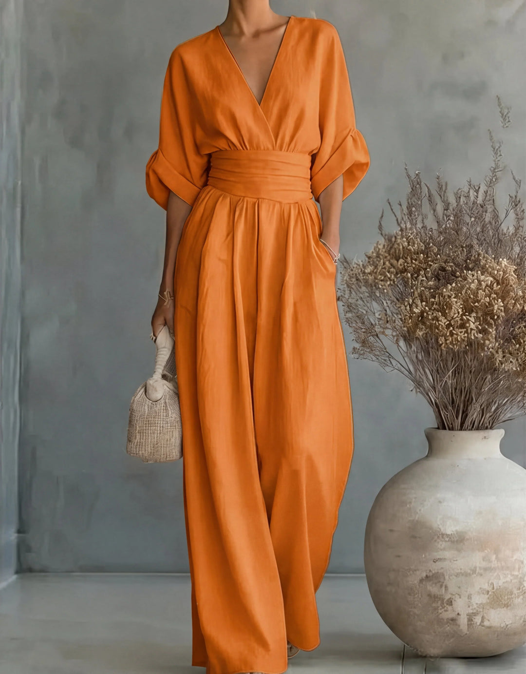 Light pink wide-leg jumpsuit with wrap bodice and side pockets