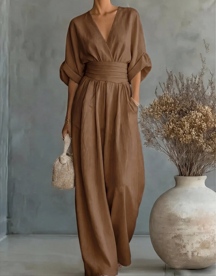 Wide-leg jumpsuit detail showing smooth fabric drape and gathered waist