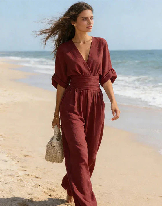 Woman in wide-leg jumpsuit with wrap bodice styled for daytime occasion