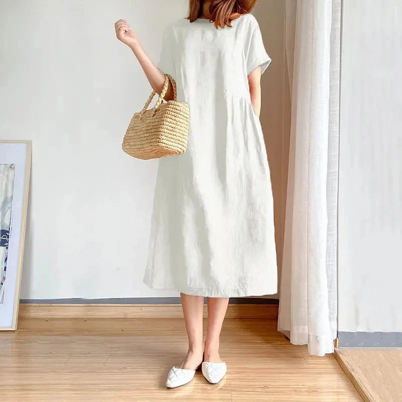 Linen short sleeve midi dress showing natural drape and breathable fabric texture in casual setting