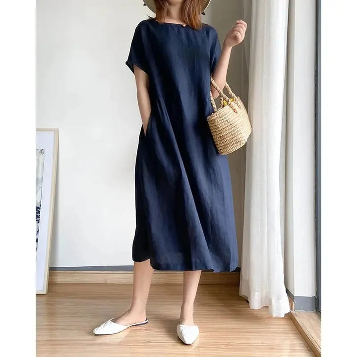 Close-up detail of linen midi dress round neckline and short sleeve construction