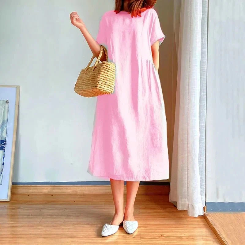 Side view of relaxed fit linen midi dress demonstrating comfortable straight cut and pocket placement