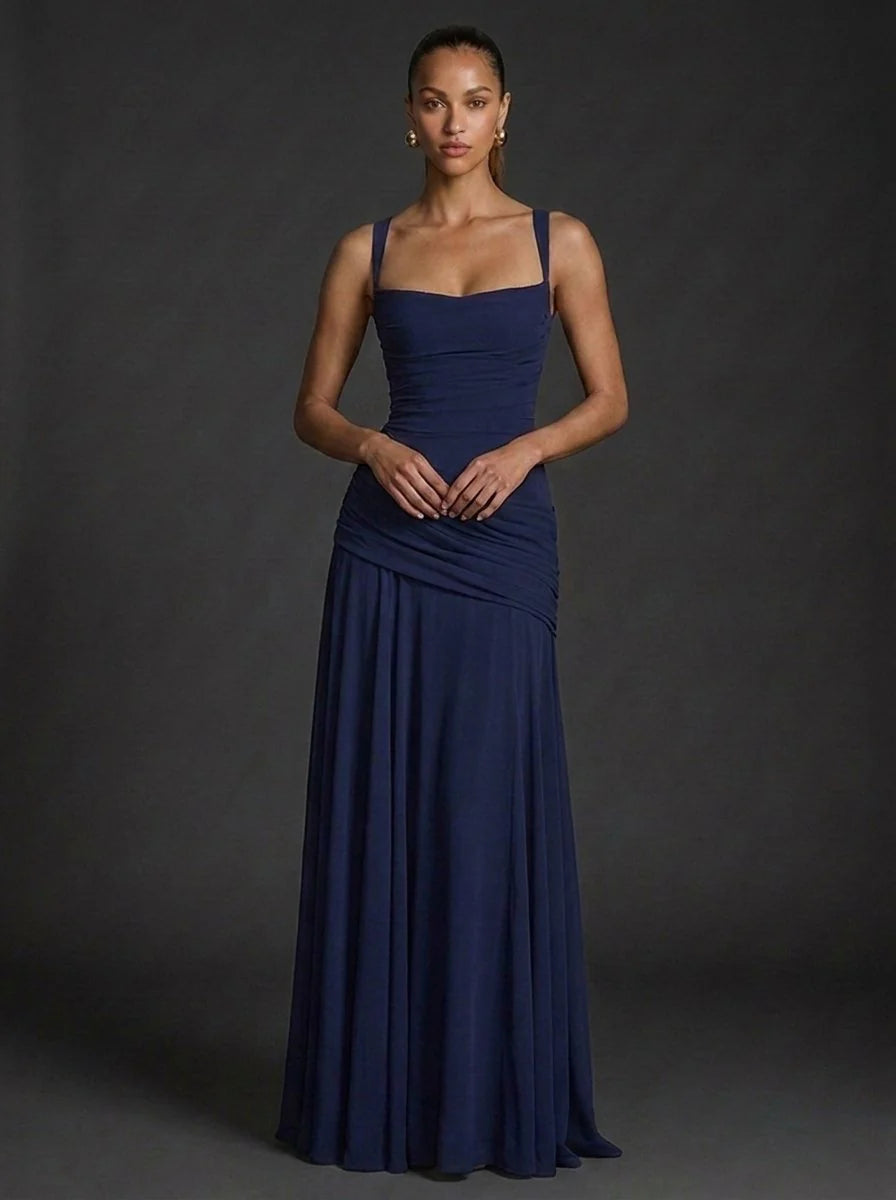 Full-length butter yellow maxi dress styled for wedding guest or summer celebration
