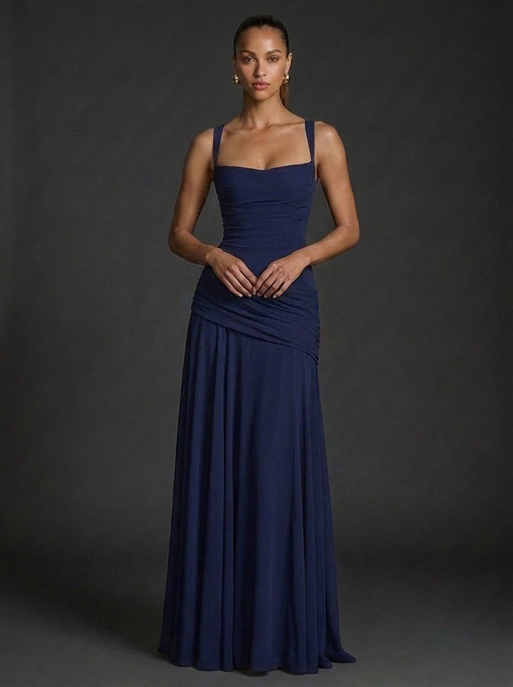 Full-length butter yellow maxi dress styled for wedding guest or summer celebration