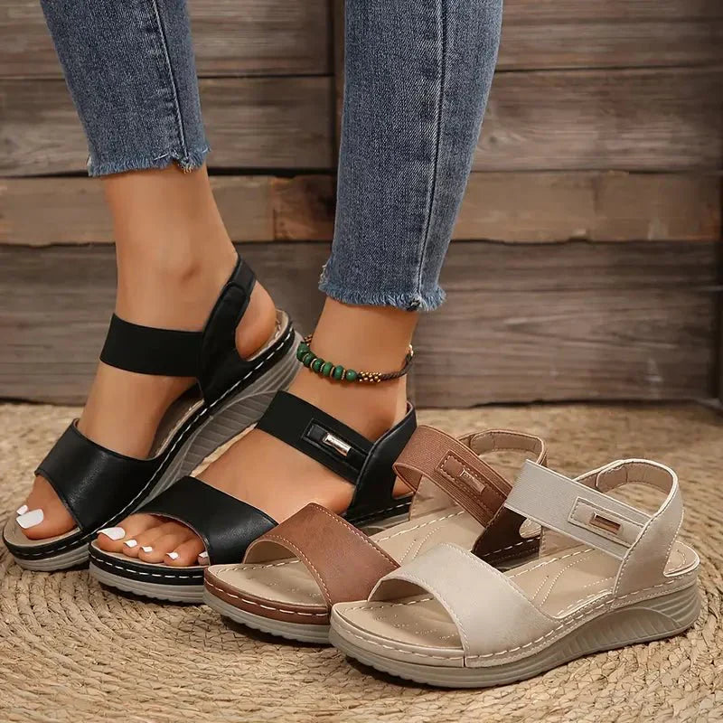 Women's summer sandals in brown featuring low wedge sole and supportive arch design