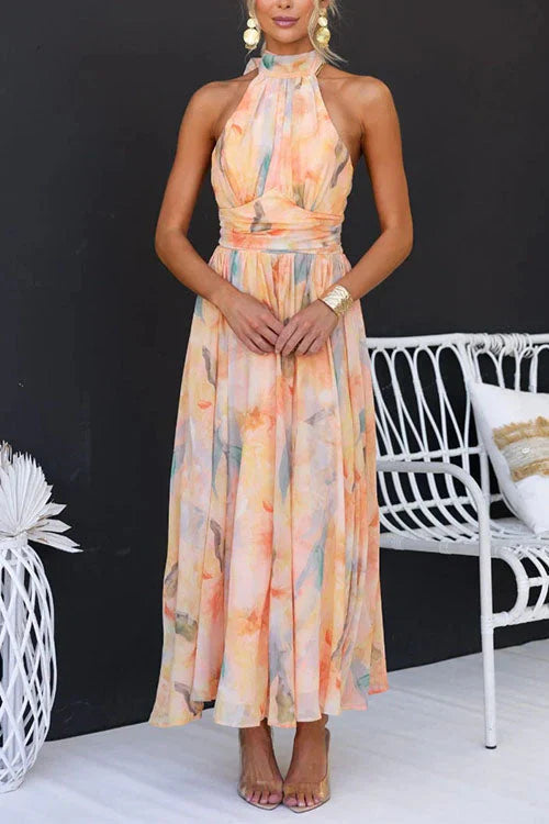 Women's Halter Watercolour Maxi Dress in soft peach, blue and cream print with flowing skirt and halter neckline