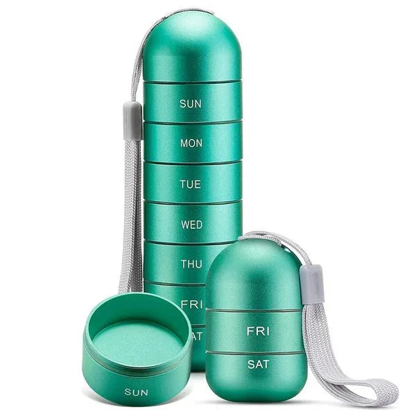Seven-day pill organiser with individual compartments labelled Sunday through Saturday in blue aluminium construction