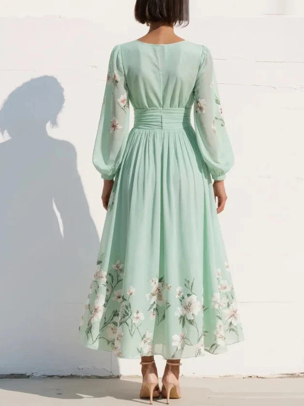 Side view of floral midi dress highlighting sheer balloon sleeves and ruched waistband