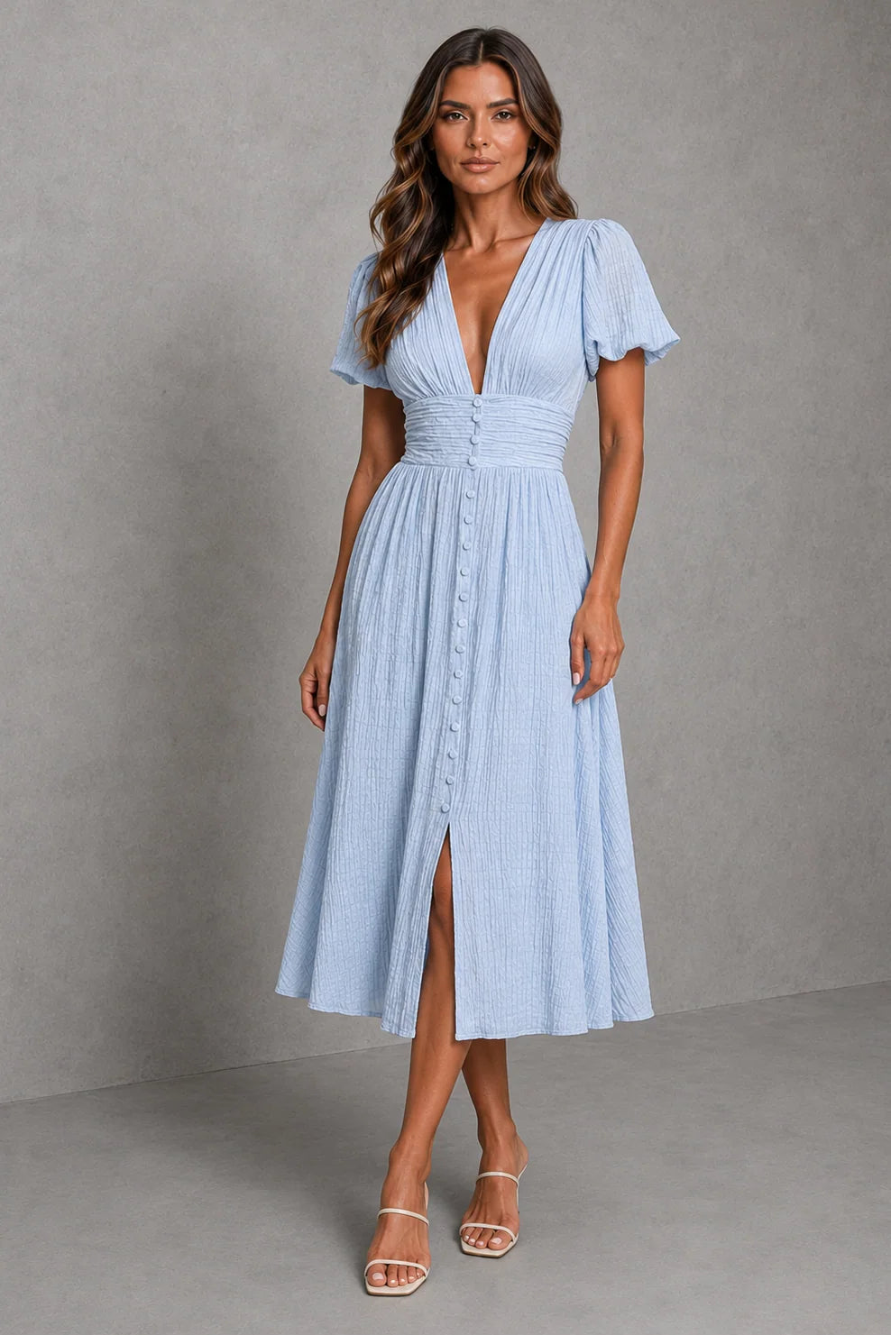 Light blue midi dress with puff sleeves, deep V-neckline, and button-through front detail for summer occasions