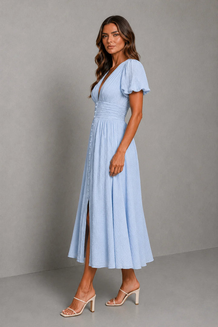 Flowing midi dress featuring ruched waist, puff sleeves, and lightweight textured fabric for garden parties