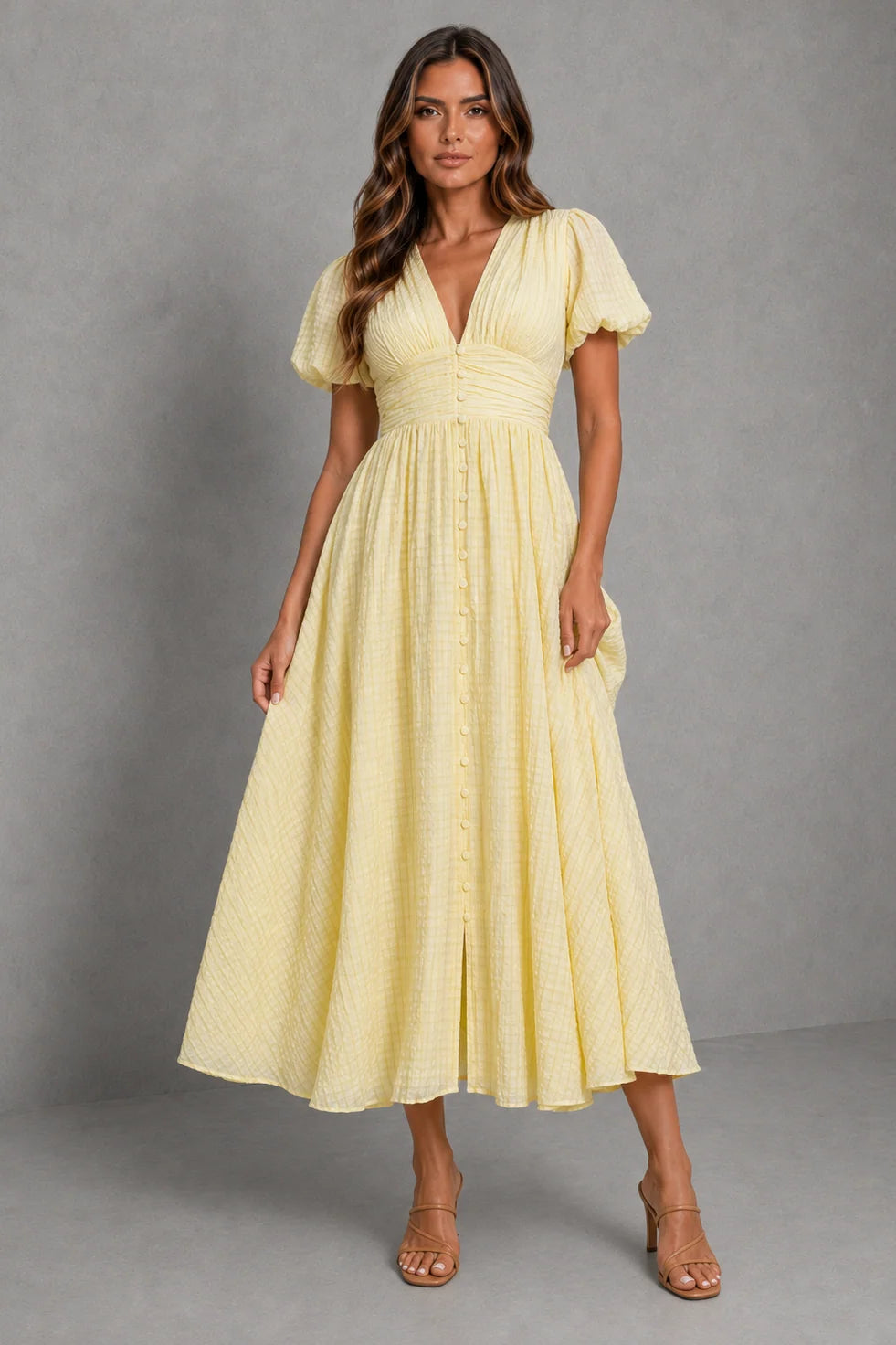 Lightweight midi dress with puff sleeves and flowing skirt, styled with strappy sandals for summer wear