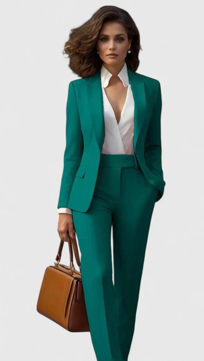 Side angle of women's coral suit set displaying structured shoulders and straight-leg trouser silhouette