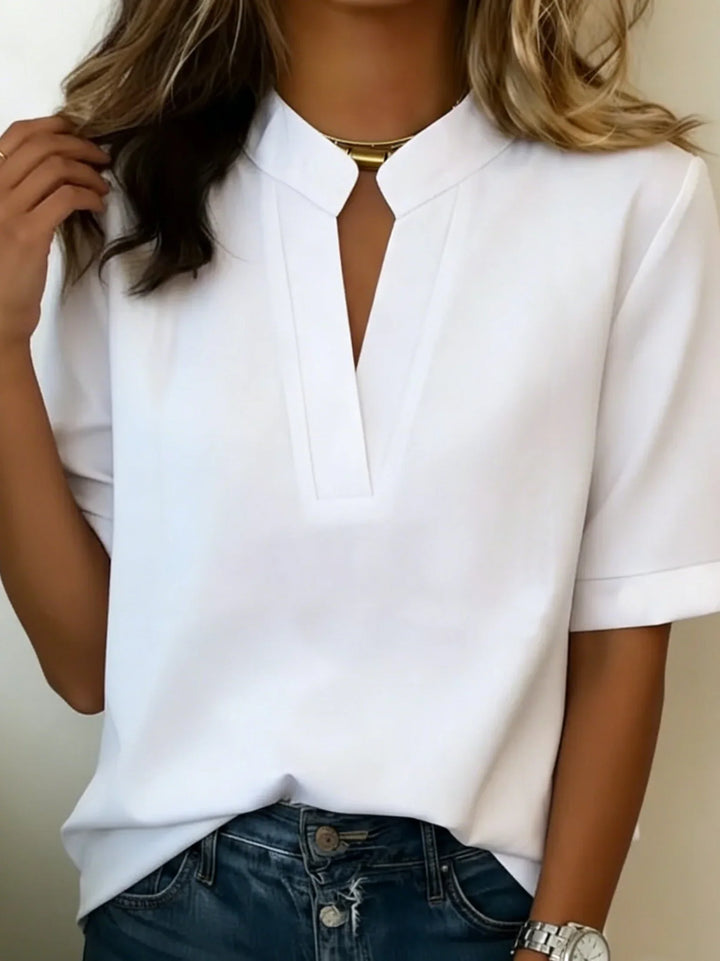 Women's V-neck blouse in light blue demonstrating flattering drape and structured collar detail