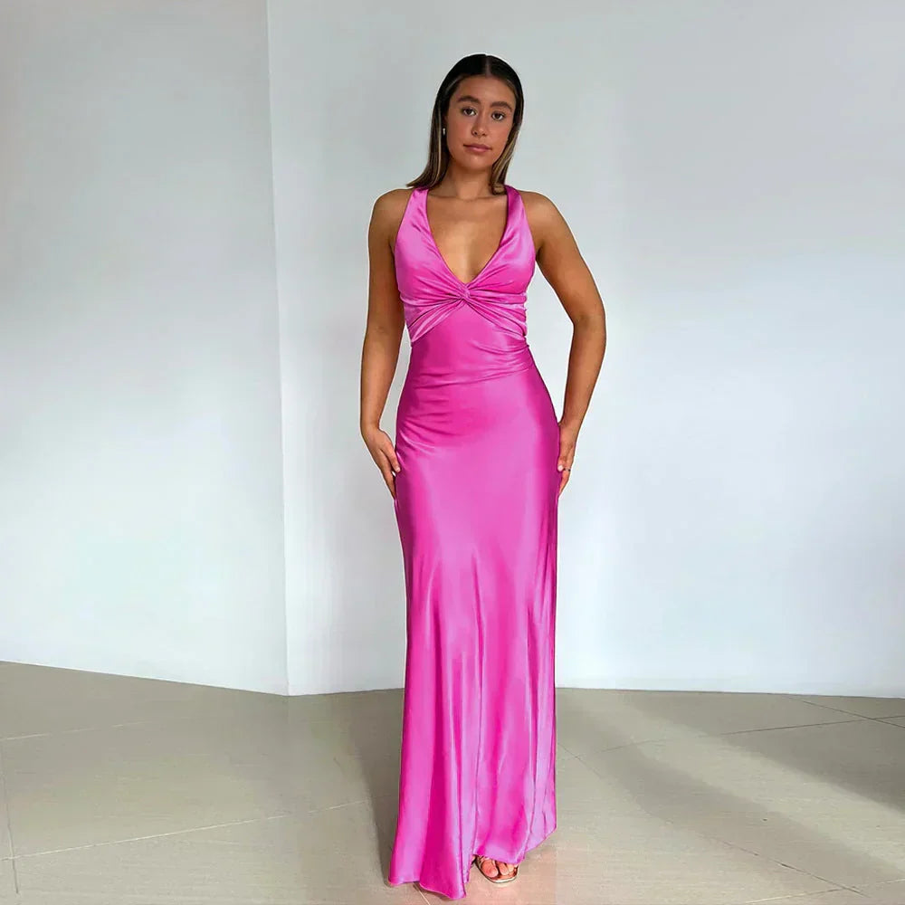 Full-length crossover neckline wedding guest dress styled with strappy heels for evening occasion