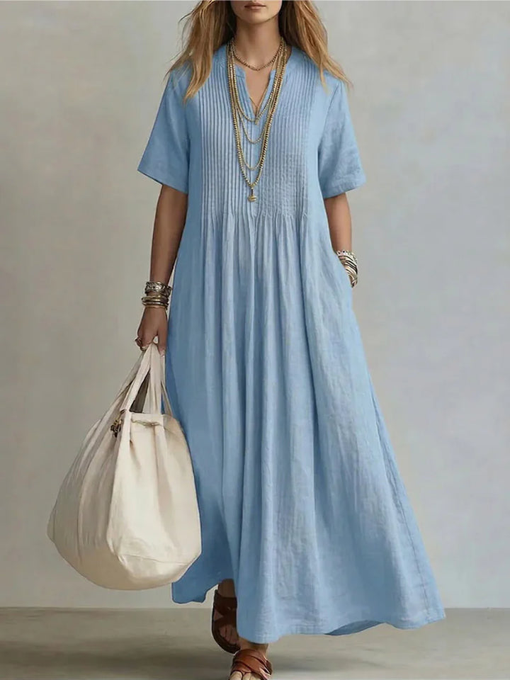 Relaxed fit pleated maxi dress with short sleeves and side pockets in bright magenta