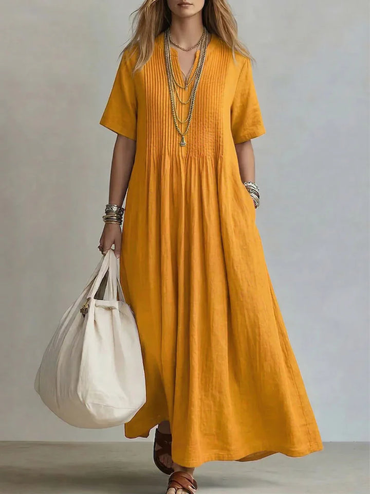 V-neck pleated maxi dress in magenta displaying gathered waist and breathable woven fabric