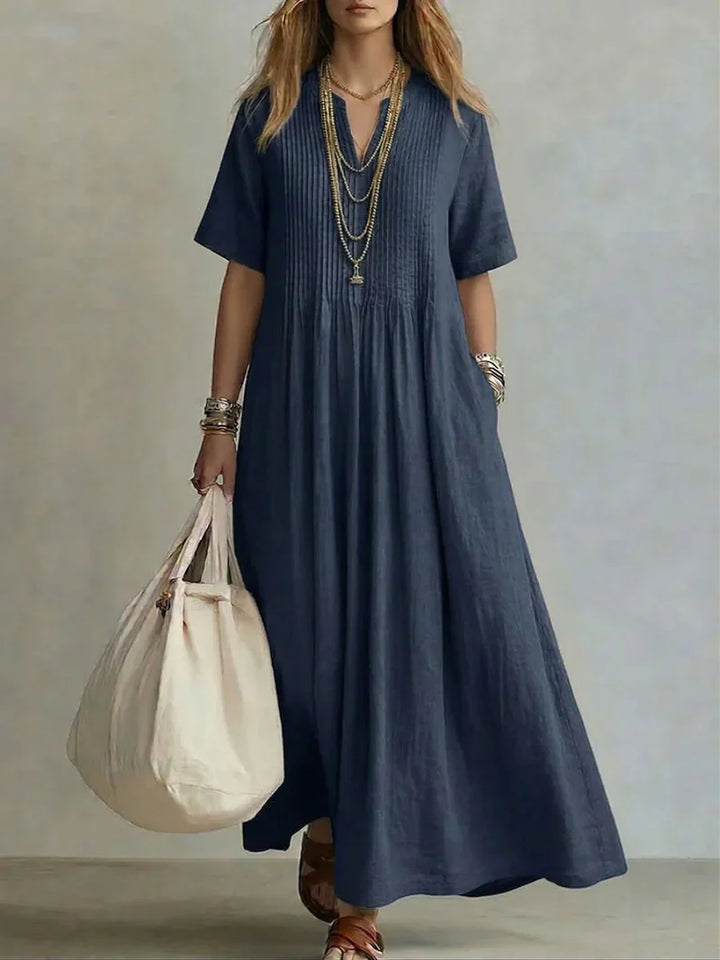 Full-length view of pleated maxi dress in magenta with A-line silhouette and soft drape