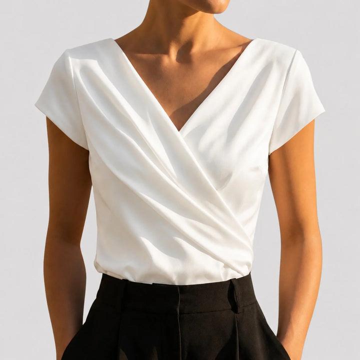 Women's draped wrap v-neck blouse in white with cap sleeves and crossover front detail