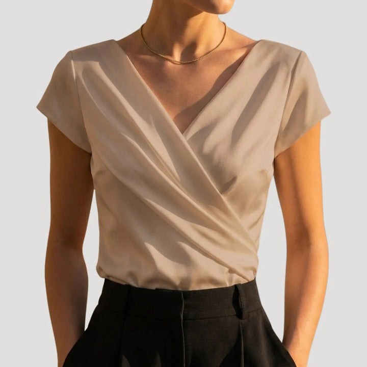 Side view of women's cap sleeve blouse with tailored fit and smooth fabric drape