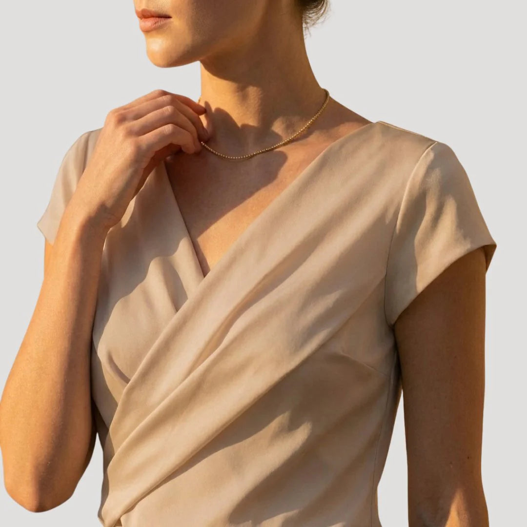 Women's white wrap blouse styled with black trousers for polished office look
