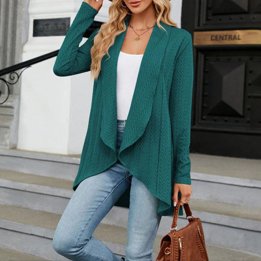 Teal open front cardigan with textured fabric and asymmetric hem worn over white top and jeans