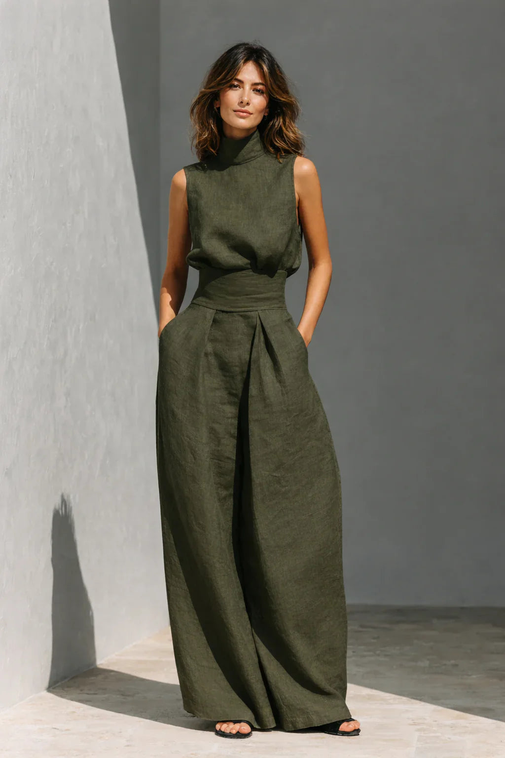 Women's matching trouser set in beige with sleeveless top and flowing wide leg bottoms