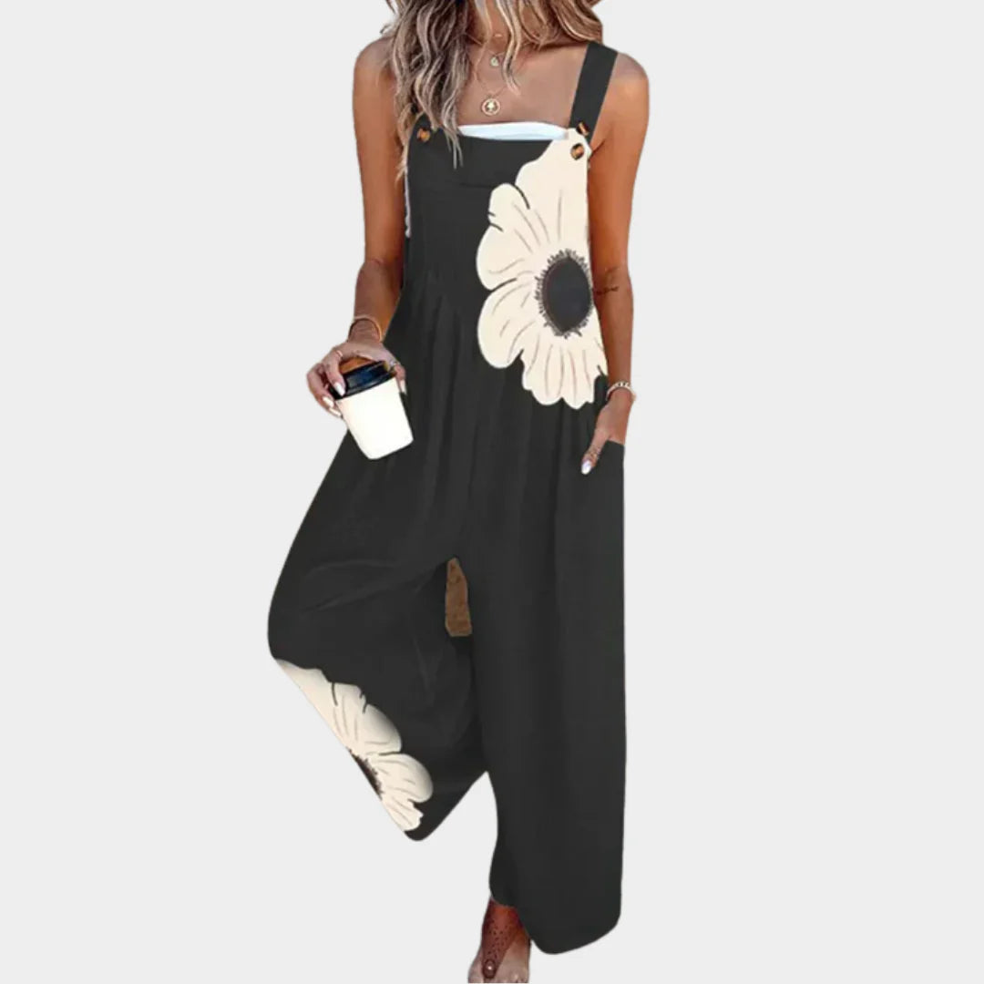 Floral print dungarees with wide leg and large daisy motif on dark base fabric
