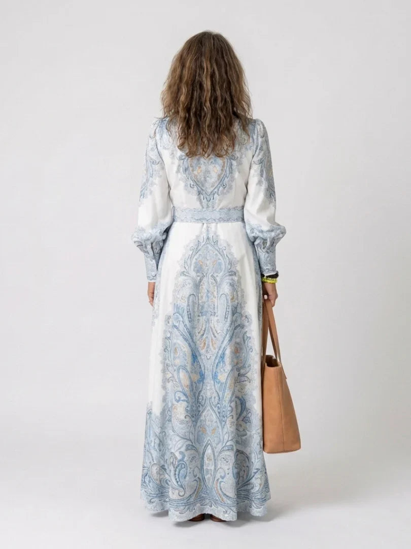 Detail of high neck collar and long sleeves with gathered cuffs on printed maxi dress
