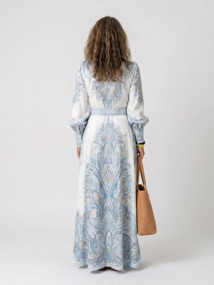 Detail of high neck collar and long sleeves with gathered cuffs on printed maxi dress