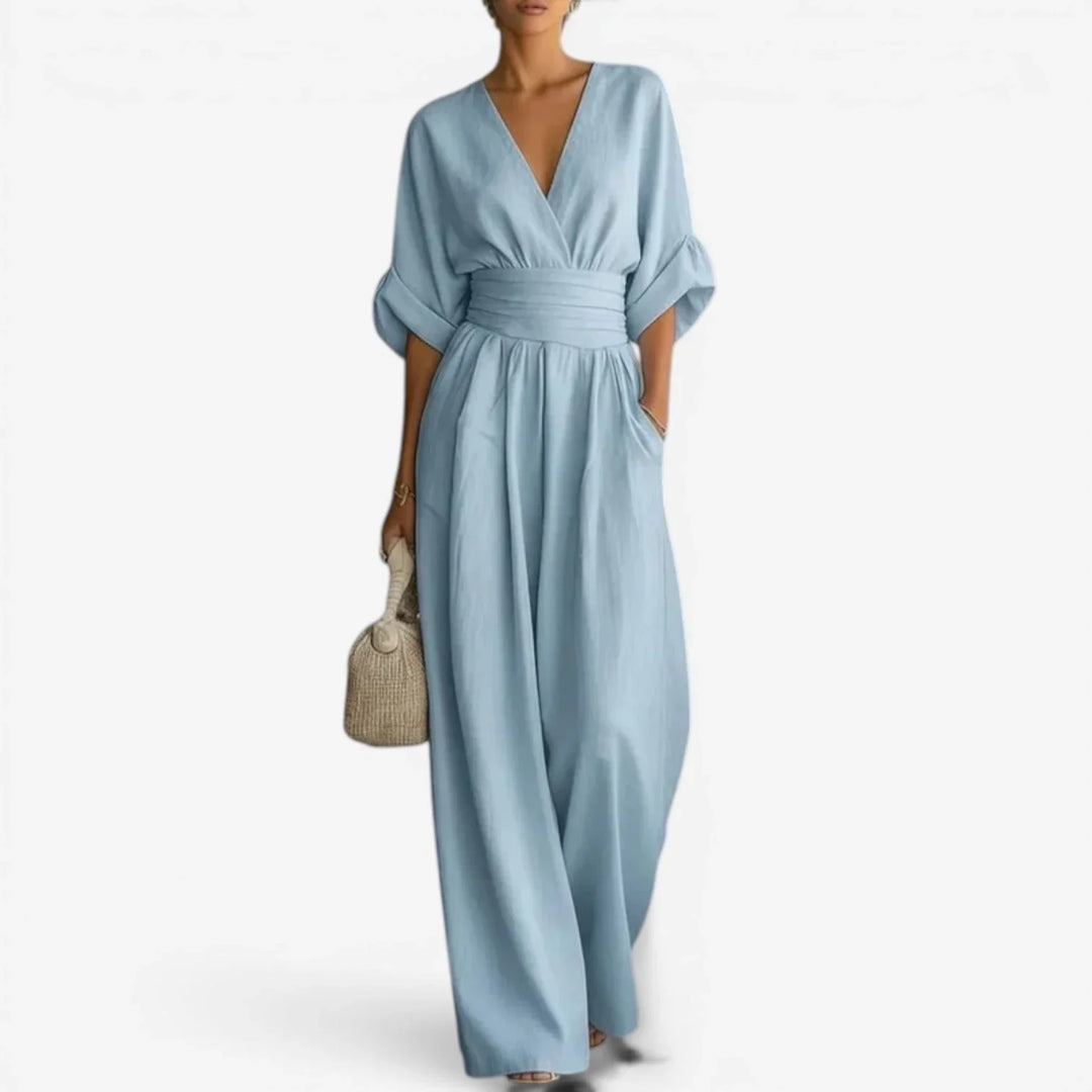 Wide sleeve V-neck jumpsuit in light blue with cinched waist and flowing wide-leg trousers