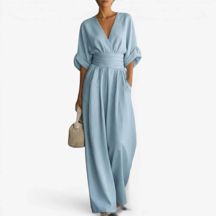 Wide sleeve V-neck jumpsuit in light blue with cinched waist and flowing wide-leg trousers