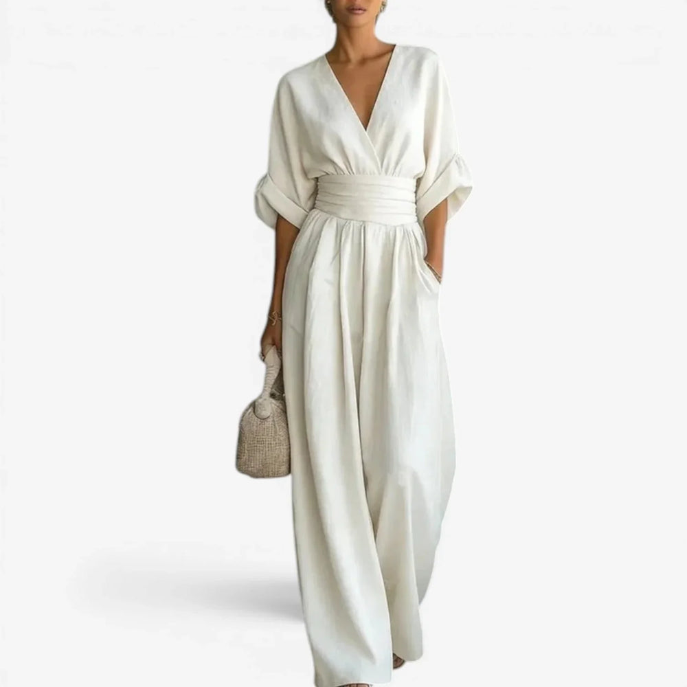 Close-up of kimono-style wide sleeves and deep V-neckline on light blue jumpsuit