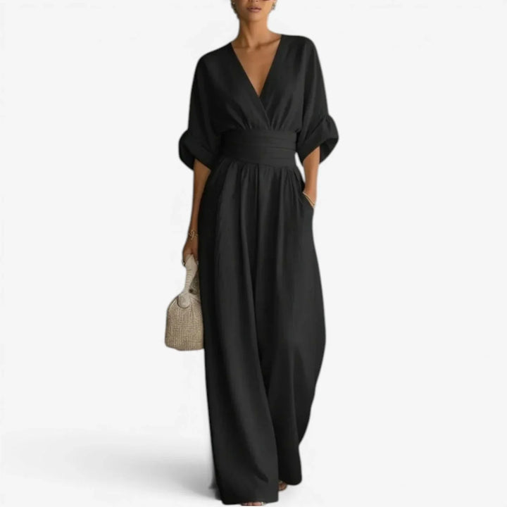 Back view of flowing wide sleeve jumpsuit with cinched waist detail