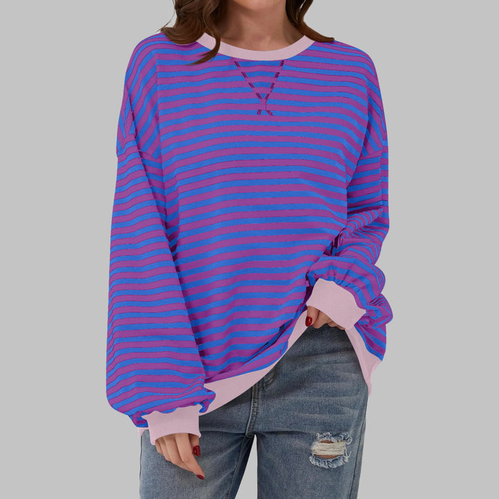 Full-length view of model wearing oversized striped sweatshirt in green and navy colourway