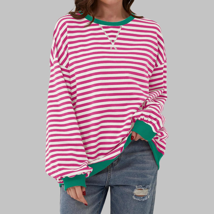 Side view of relaxed fit striped sweatshirt showing oversized silhouette and dropped shoulder seam detail