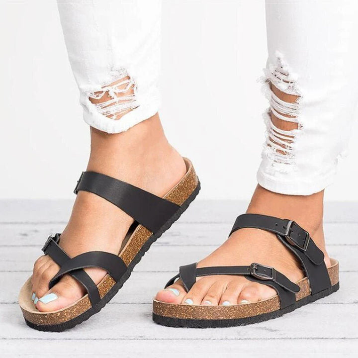 Women's cork footbed toe-post sandals with adjustable black buckle straps and natural cork sole
