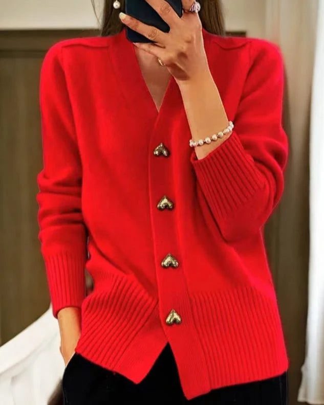 Women's heart button cardigan styled with black trousers for a layered look