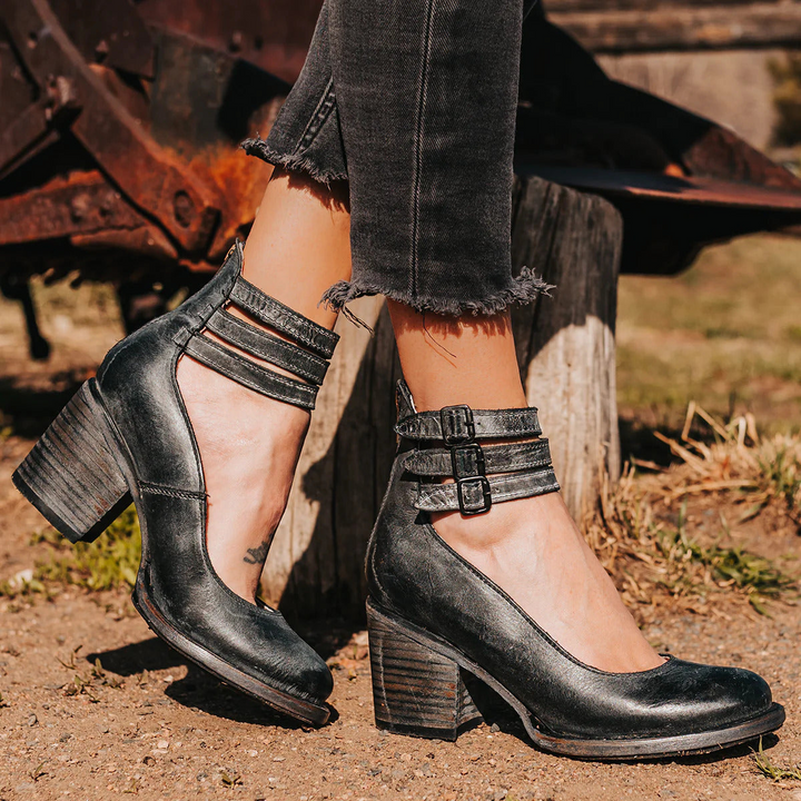 Woman pairing ankle strap heels with midi skirt for versatile day-to-night styling