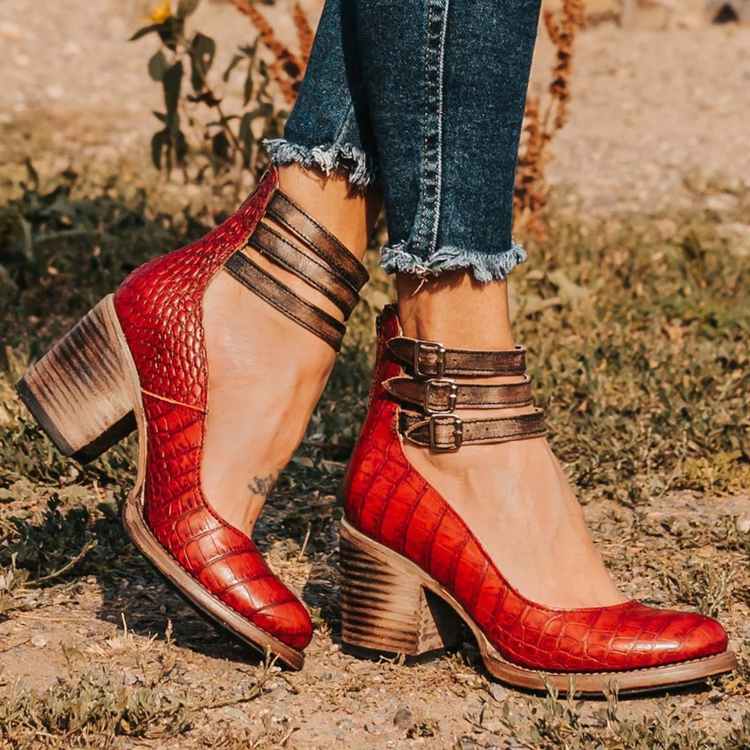 Detail of smooth upper finish on strappy ankle strap heels with vintage-inspired buckle detail